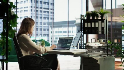 Woman in a powerful executive role oversees budget analysis for investment strategy, showcasing commitment to financial success and sustainable growth in the corporate sector. Camera B.