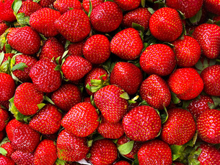 Strawberry background. Red ripe organic strawberries on market counter. Texture of sweet fresh strawberries as background, closeup