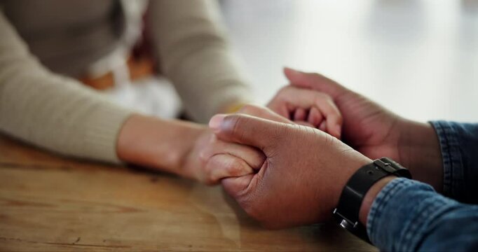 People, holding hands and support in home with stress, anxiety and sad woman. Couple, financial crisis and gesture at table for trust, healing relationship and depression for infertility with fear