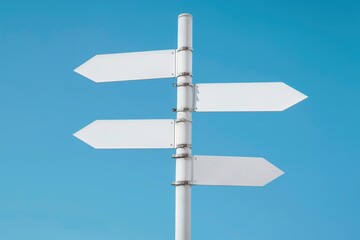 A white street sign with four arrows pointing in different directions. The sign is on a pole and is against a blue sky
