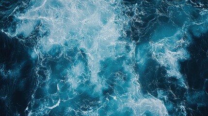 Fototapeta premium Aerial view of turbulent ocean waves in deep blue water.