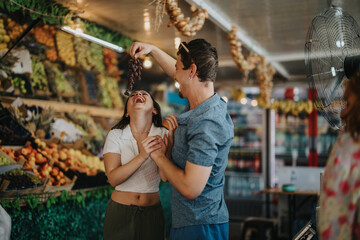 Two friends enjoying a fun moment while buying fresh fruits and vegetables at a local greengrocer. They share laughter in the vibrant market atmosphere.