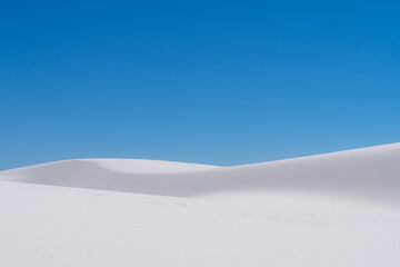 white sand dunes under blue sky