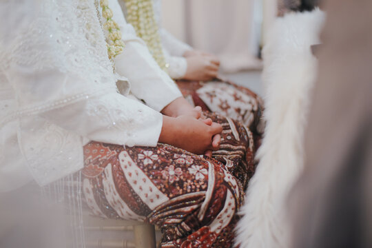 Grooms and bride hand on Islamic prenuptial agreement. Indonesian&rsquo;s wedding, akad nikah