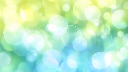 Obraz premium A soft, dreamy bokeh background with overlapping circles in pastel shades of blue, green, and yellow. The abstract light effect creates a soothing and airy atmosphere, perfect for serene designs.