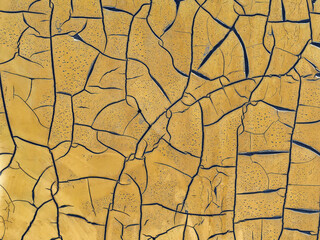 Abstract background image of a smooth mustard yellow colored surface divided into segments by...
