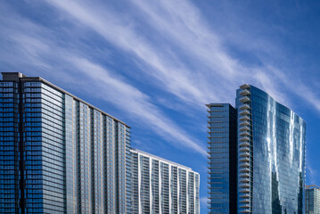 Autumn Cityscape of Blue Sky and High Thin Cirrus Clouds Above Building Roofs.