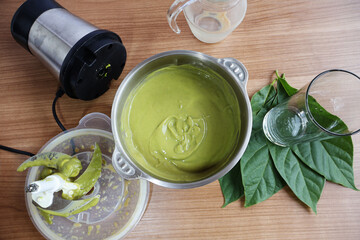 Rich and finely blended avocado pulp in a bowl. Place it in the center between the glass over the...