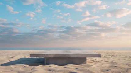 Concrete podium on sandy beach with neutral backdrop. Simple setting for showcasing products.