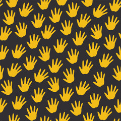 seamless pattern of yellow handprints on a black background