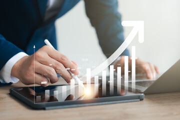 Investors use laptops to analyze stock market, investment strategies. and business growth analysis,...