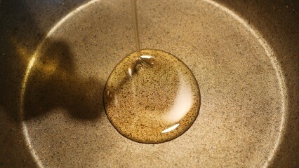 Close-up of frying pan on which vegetable oil is poured for cooking, nonstick cookware designed specifically for achieving culinary excellence in your kitchen. cooking experience with quality tools