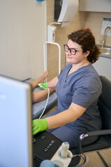 Specialist at the workplace conducts an ultrasound diagnosis