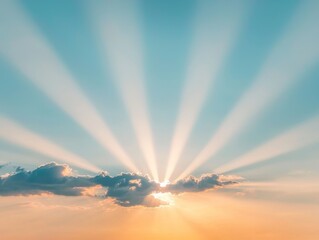 Fototapeta premium A stunning capture of radiant sunlight emerging from behind clouds, casting beautiful rays across a clear blue sky.