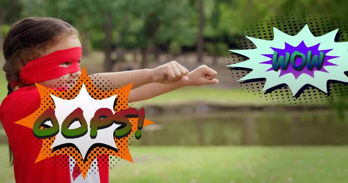Wearing superhero costume, child with oops! and wow comic text animation in park