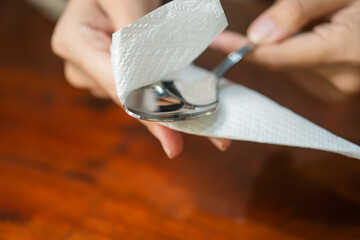 Preparing to Serve Food with Spoon and Paper Towel
