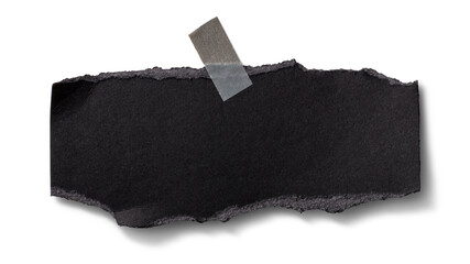 壁にテープで貼られた、黒い紙の断片
