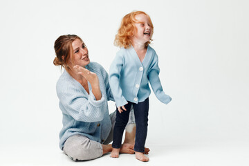 Happy mother and daughter spending quality time together laughing and smiling in living room