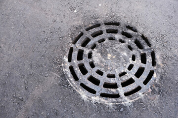 round grate for draining waste water, drainage, rolled into asphalt