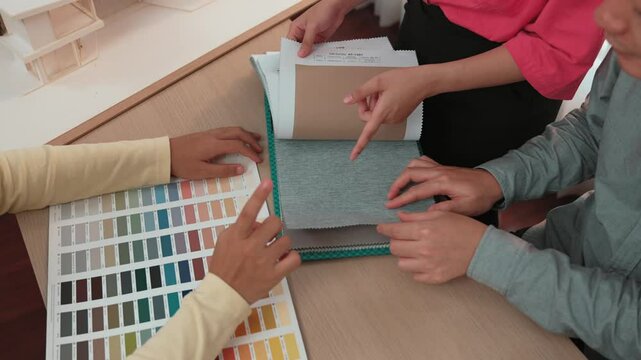 Slow motion hand closeup architect and interior designer presenting textile material and color from color palette for interior house design based on customer oversee and supervised. Variegated