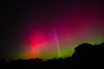 Bright pink and red aurora borealis with Big Dipper visible