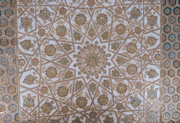 A large, ornate carpet with a star pattern