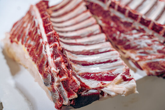 A large piece of meat is cut into strips