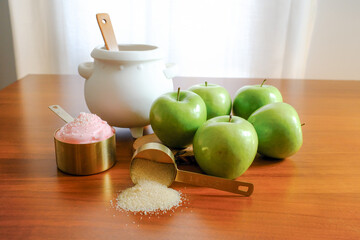 White Cauldron with Green Apples and Gold Measuring Cups
