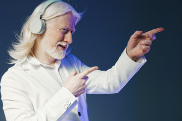 elderly man with long white hair and headphones, wearing a stylish white suit, pointing...