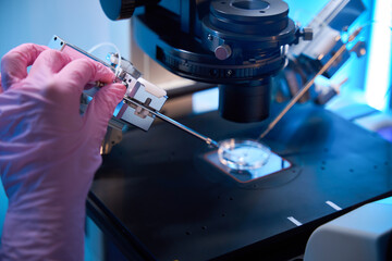 Microscope setup with micromanipulator performing detailed lab work
