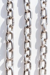 Obraz premium Bright and High-Contrast Silver Chains Pattern on a Crisp White Background with Soft Shadows