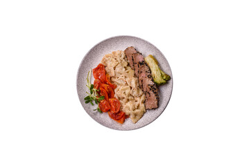 Bowl with slices of baked tuna with broccoli, tomatoes and fusili pasta