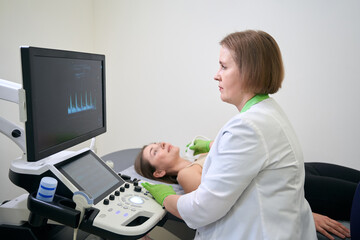 Doctor completing ultrasound procedure while reviewing results