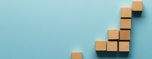 Wooden Blocks Arranged in an Upward Trend on a Blue Background