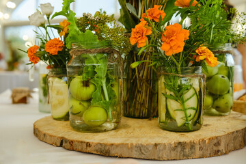 Concept of festive decoration - fruits and plants in jar with water
