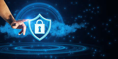 Hand pointing at a glowing lock icon on a shield representing cybersecurity on a dark digital background.