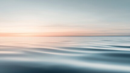 Fototapeta premium Calm, serene seascape with a soft, pink-hued sky at sunset.