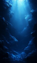 Obraz premium A deep blue underwater scene with a ray of light shining down through the water.