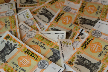 close-up: Moldovan leu banknotes of 500 lei lying randomly on a table