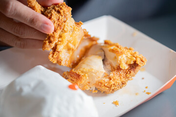 Close-Up of Crispy Fried Chicken in Hands