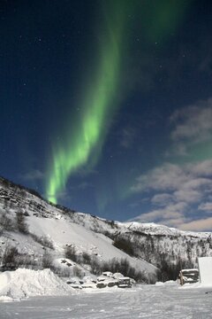 Northern lights over snowy mountain