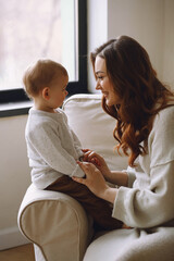 Fototapeta premium Happy pregnant woman playing with her toddler son. Elder brother waiting little baby