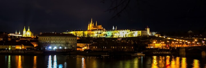 Fototapeta premium Night view of Prague Castle and Charles Bridge illuminated during the Christmas season in Prague, Czech Republic