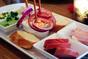 A festive German breakfast spread featuring fresh bread, ham, and cheeses, perfect for a cozy holiday morning