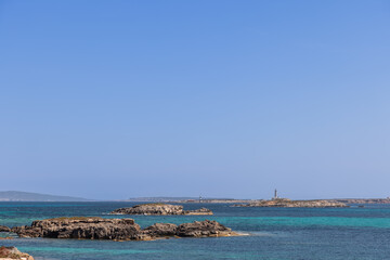 The tranquil turquoise waters off the coast of Ibiza stretch towards Formentera distant...