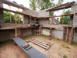 A construction site with a cement mixer inside. Scene is that of a work in progress, with the...