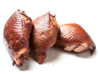 Smoked chicken thigh on the bone on white background. High quality cooked meat product ready to...