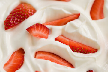 Closeup of fresh chopped strawberries in white yogurt