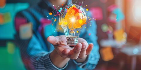 hand with bulb and light beam and paper sprinkles, creative ideas for developing a startup business or company, with a blurred background of a modern office