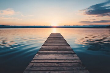 Obraz premium Wooden pier stretching towards the sunrise over a lake